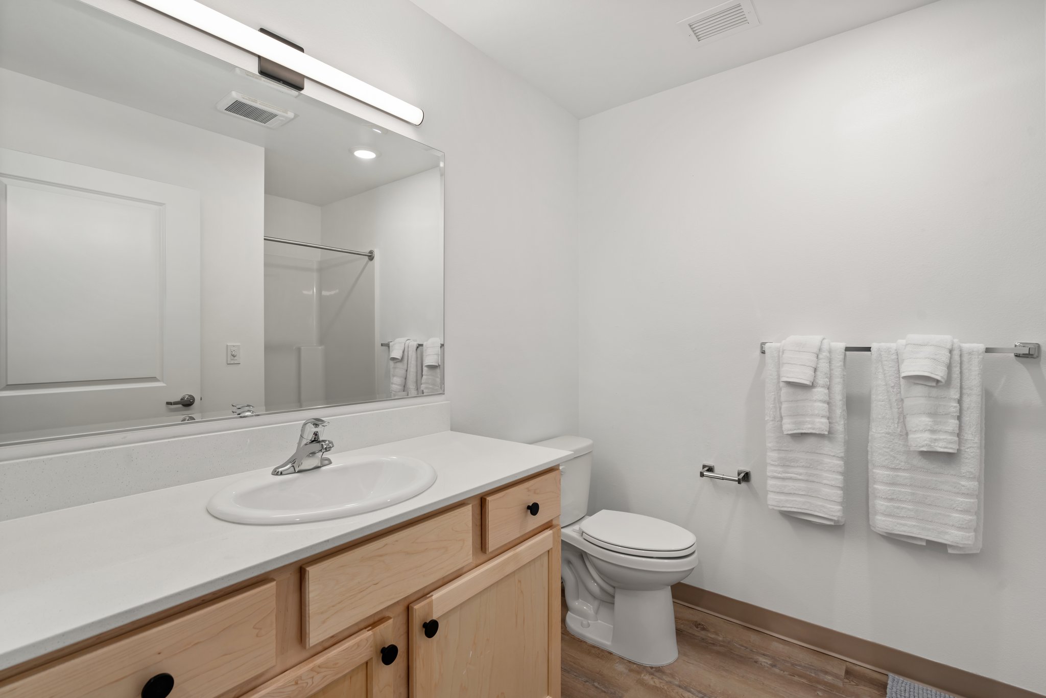 View of bathroom sink and toilet.