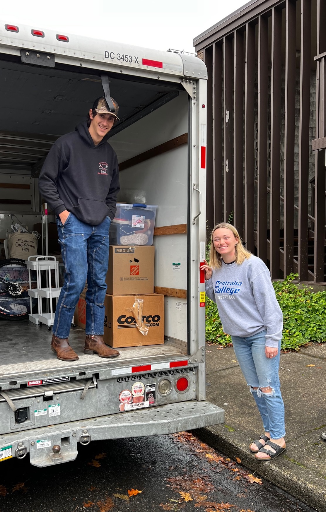 Moving truck and happy movers.