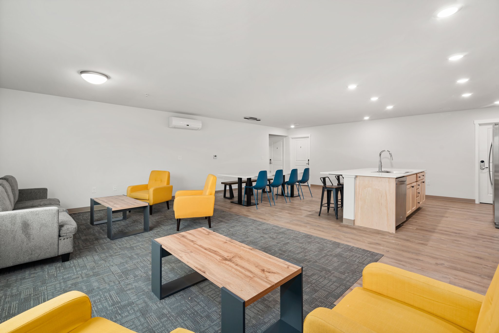 View of dining table and kitchen island from sitting area.